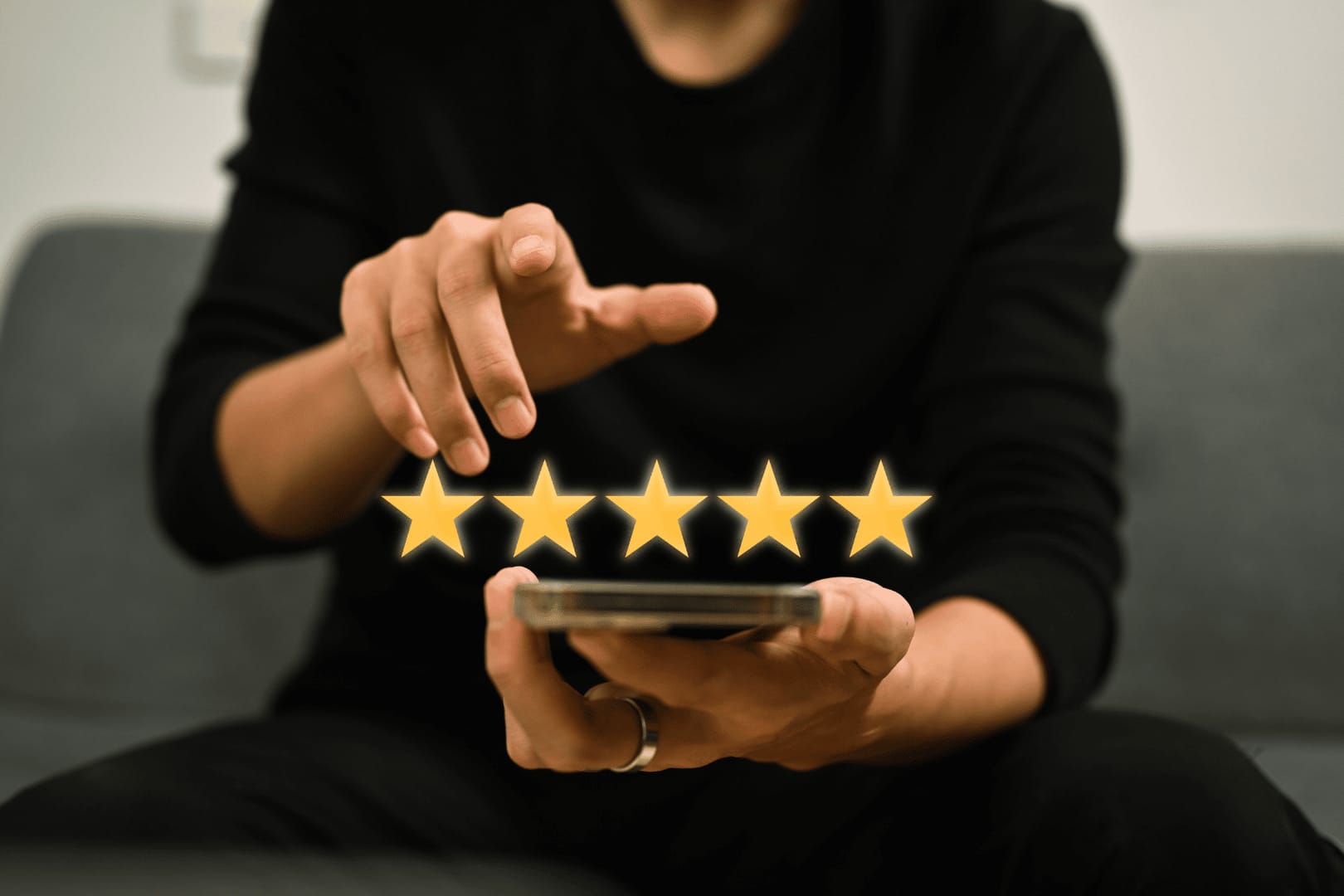 Hand hovering over a five-star rating on a tablet, representing customer feedback or satisfaction.